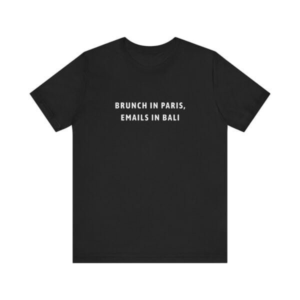 Black travel shirt with “Brunch in Paris, Emails in Bali” text design on front